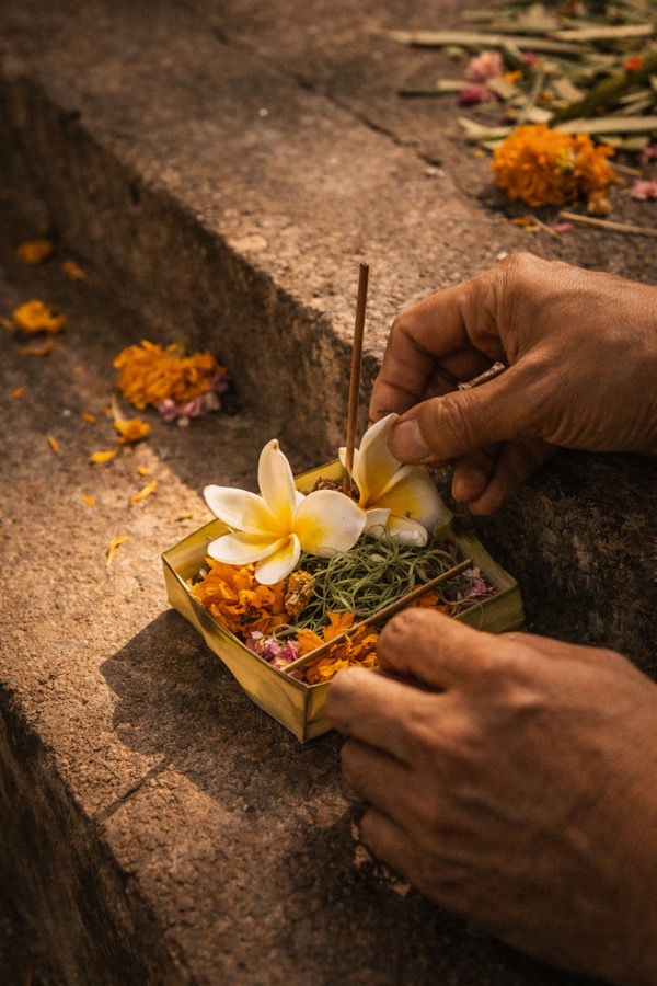 Creating a canang sari offering