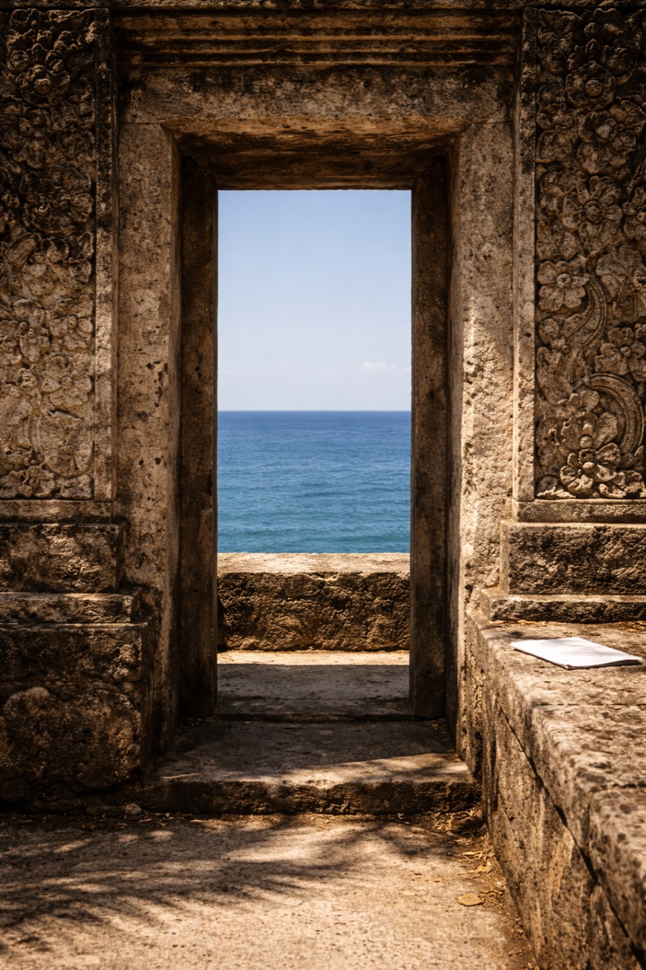Ancient Balinese temple doorway framing the Indian Ocean